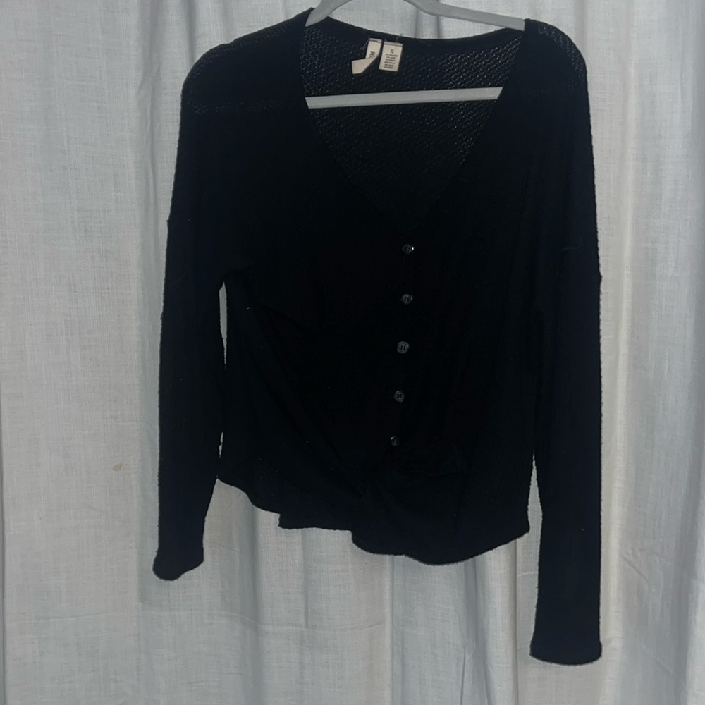 Black v-neck sweater. You can tie the bottom or you can leave it hanging